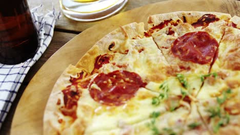 Delicious-pizza-with-a-glass-of-beer-and-beer-bottle