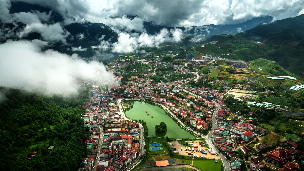 Wide aerial hyperlapse view over touristic Sa Pa in Vietnam with mountain fog