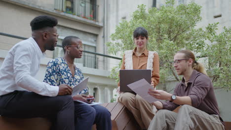 team sharing business ideas on outdoor rooftop terrace