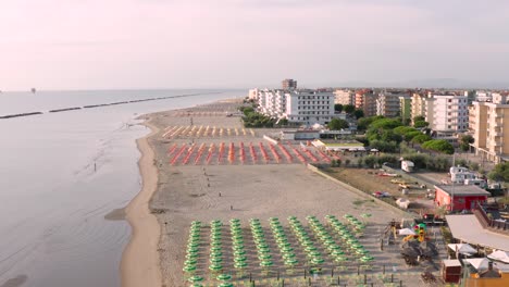 aerial view of sandy beach with umbrellas and gazebos