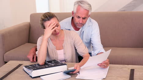 worried couple working out their finances