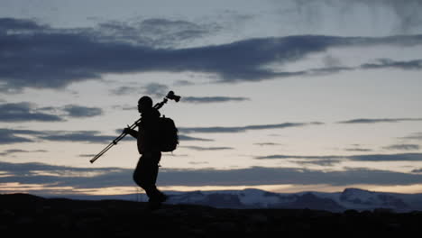 photographer hiking in iceland at dusk