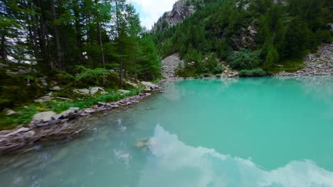 Lagazzuolo-Lake-amazing-view-of-the-turquoise-waters,-aerial-FPV-flying-above