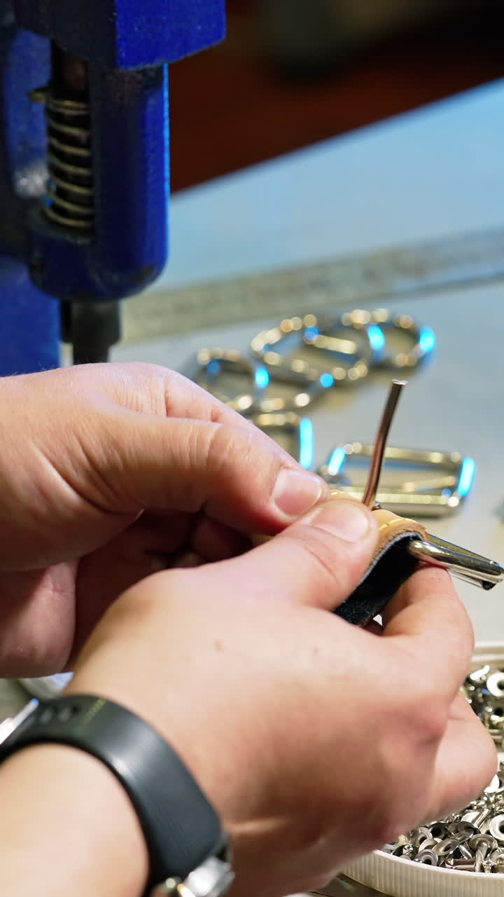 Tailor hands at work in fabric. Close up of work process of sewing machine in factory. Vertical video