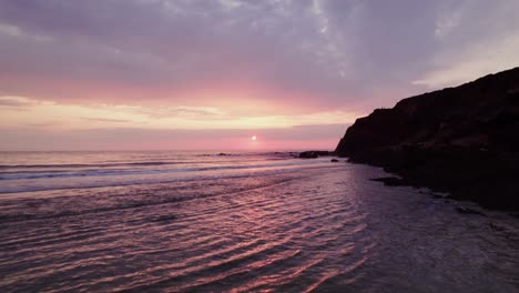 sunset at the beach with cliffs