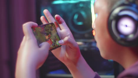 teenager playing mobile game on smartphone