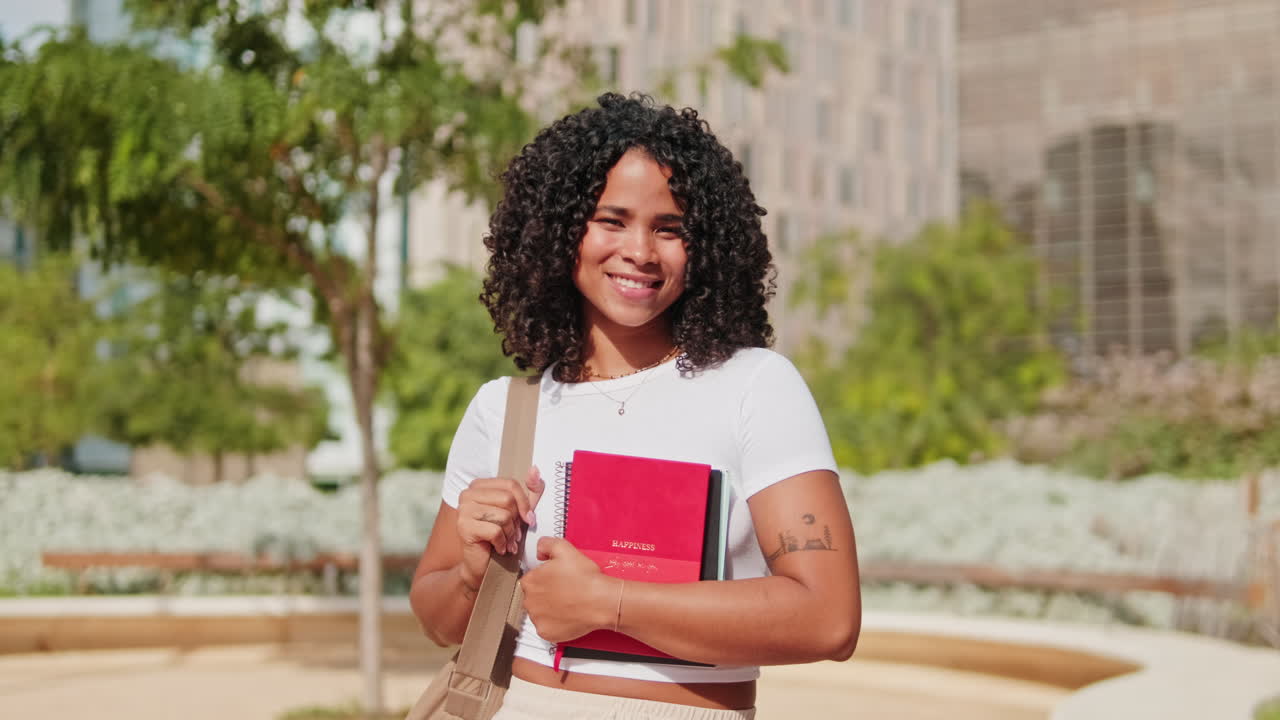 Young curly African-American girl, female student with school bag and books in
