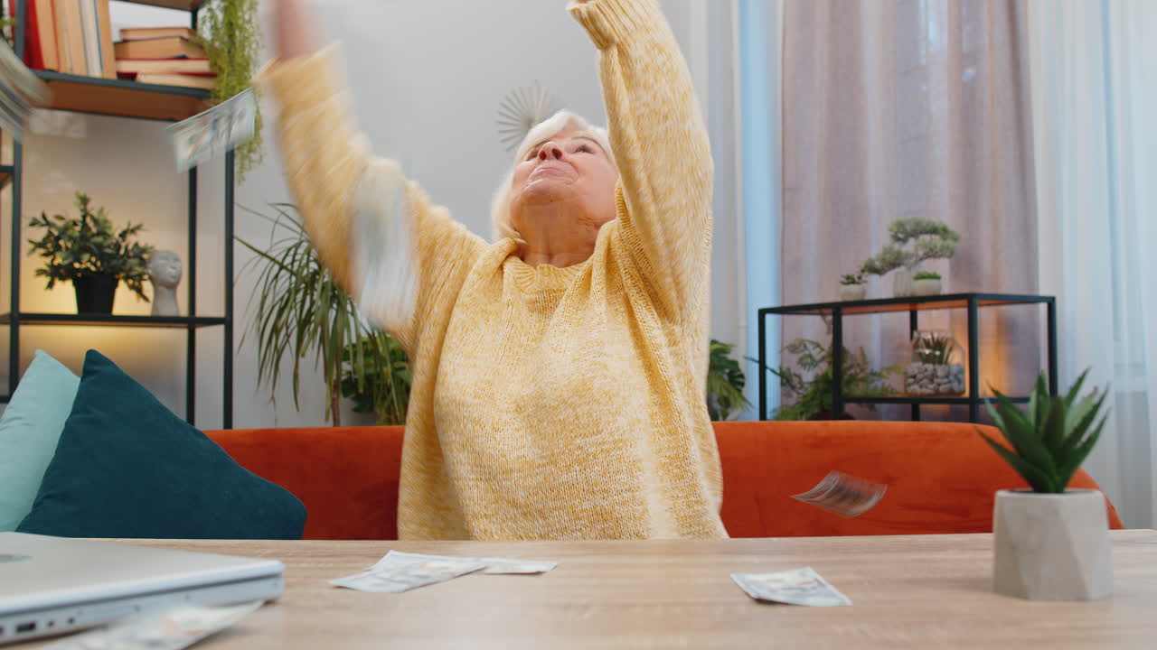 Money cash dollar rain falling on senior woman celebrating success win pension lottery jackpot luck