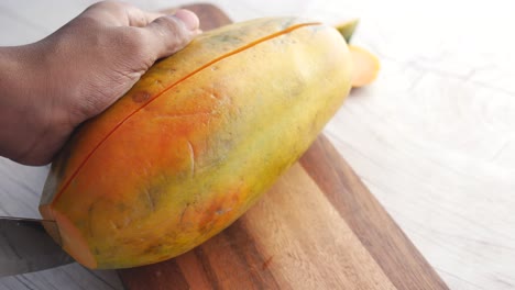 Slice-of-papaya-on-white-plate