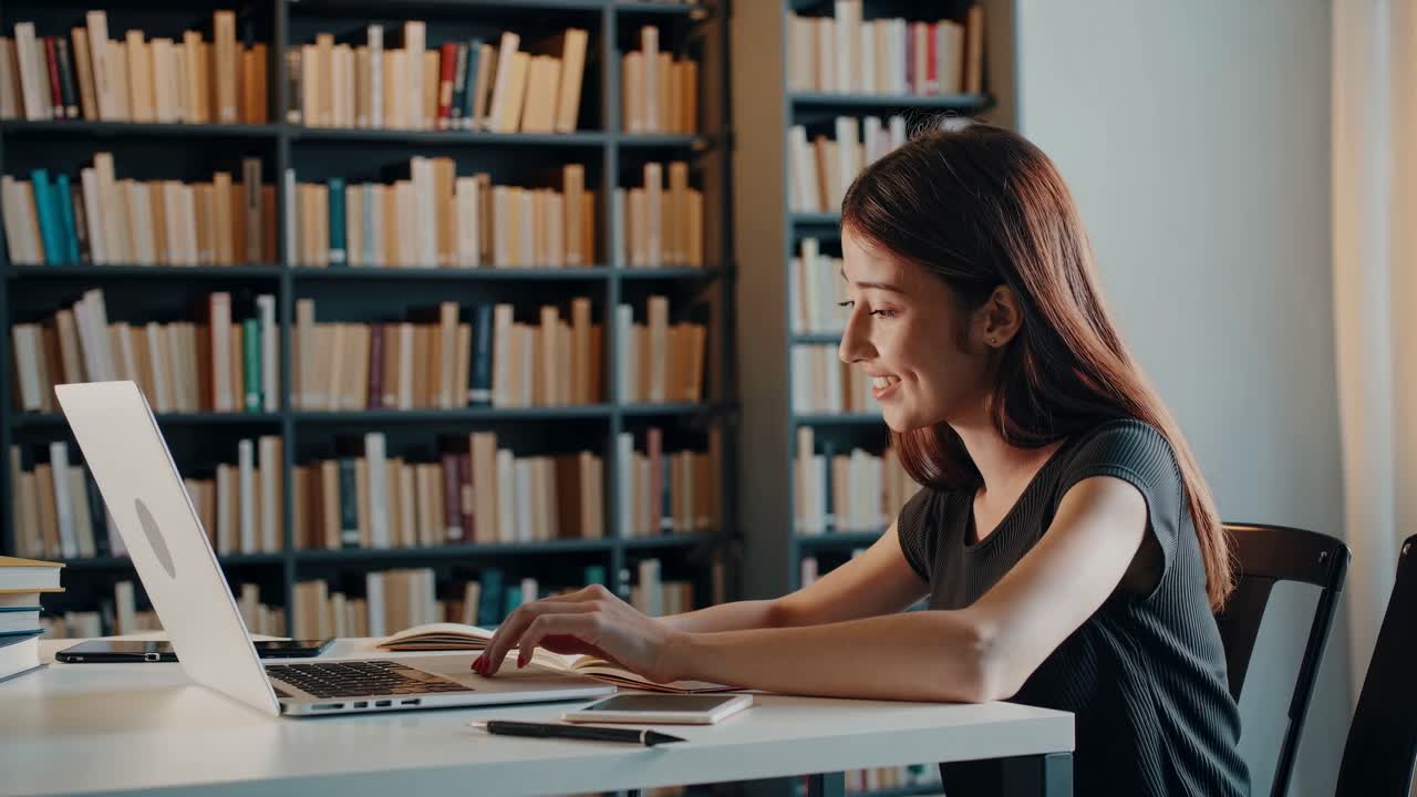 Woman Studying in Library with Laptop