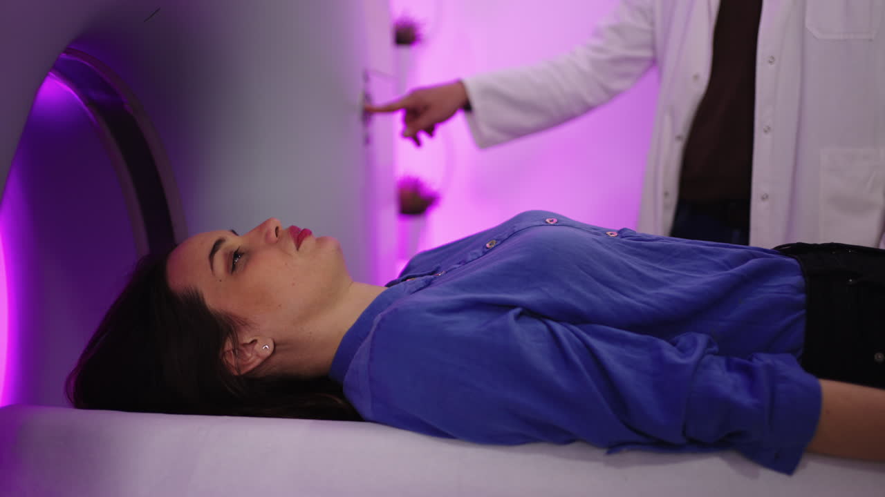 Woman Undergoing Medical Imaging Scan with Doctor