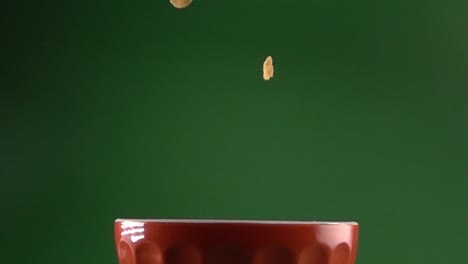 corn flakes slowly falling on a plate