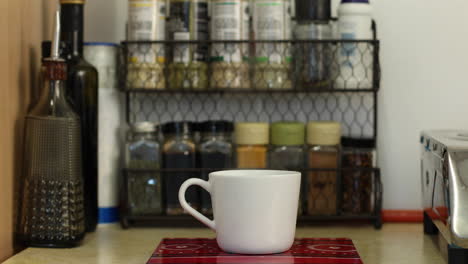 a steaming cup of coffee in the kitchen