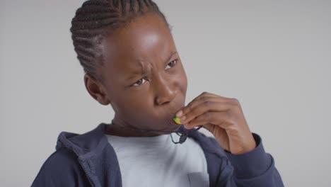 studio shot of boy on asd spectrum using sensory chew toy to calm himself and de-escalate anxiety 3