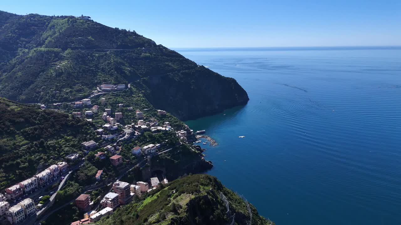 Drone footage of a small village on the coast with seagulls of Cinque Terre in Italy.