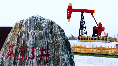 close up industrial construction oilfield kowtow machine rig pumpjack derrick working for crude oil production in a desert landscape