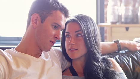 Couple-using-digital-tablet-in-living-room