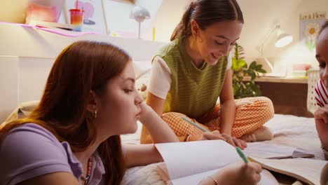 teenage girls studying together in a bedroom