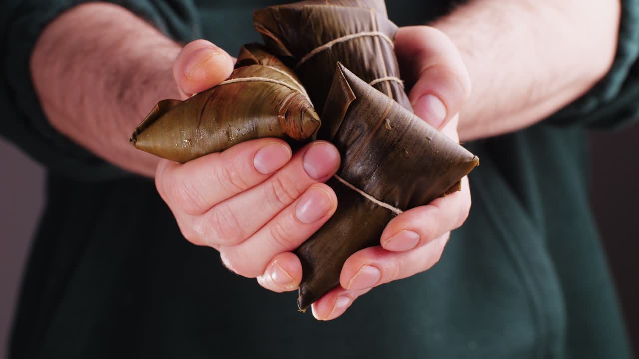 Hands holding Zongzi