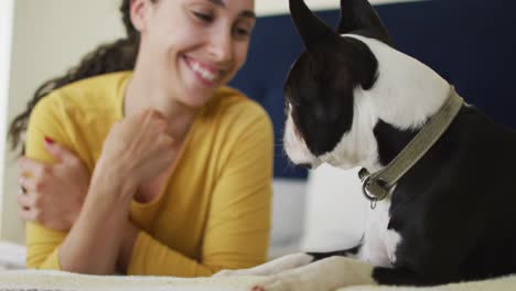 caucasian woman is playing with his dog at home