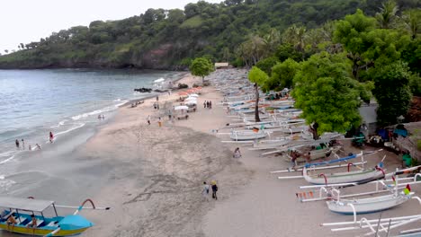 Aerial-drone-wide-shot-over-vacation-beach-with-tourists-in-Bali