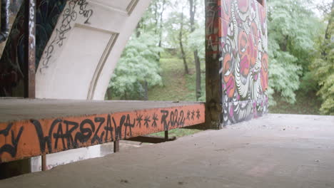 caucasian boy skateboarding in a ruined building.