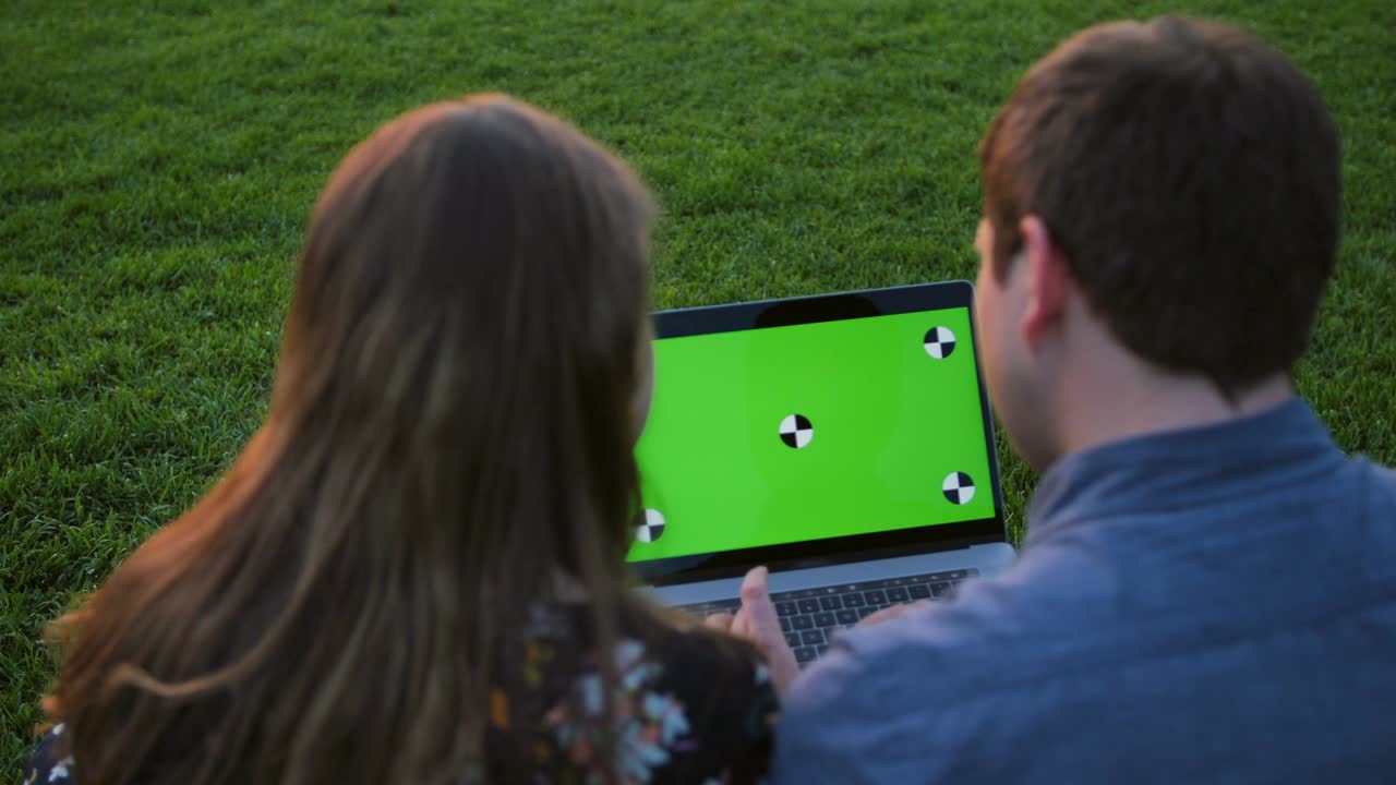 A happy couple using notebook