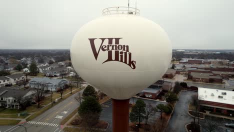 aerial close up of vernon hills, illinois logo on a water tower, flying and revealing the city