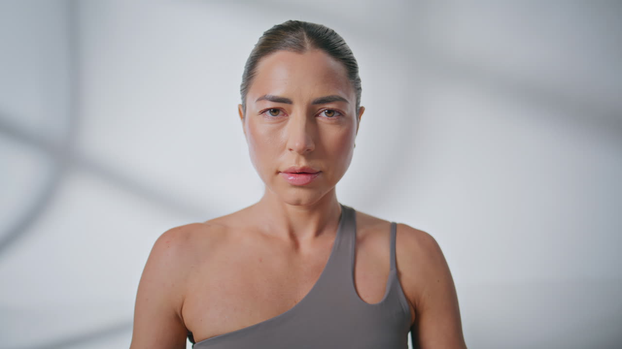 Closeup peaceful lady meditating at studio. Serene girl breathing deep inhaling