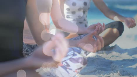 animación de puntos de luz sobre diversas mujeres practicando yoga y meditando en la playa