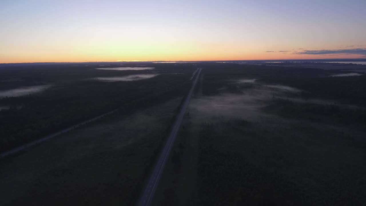 drone shot of the Trans Canada highway early in the morning with low lying fog covering the road