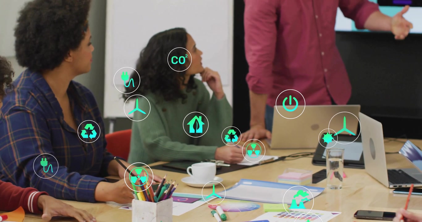 designers collaborating around table, with floating green eco-icons illustrating sustainability