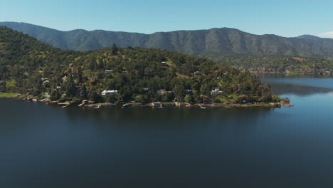 aerial view of aculeo lagoon in chile, surrounded by scenic mountains and lush greenery