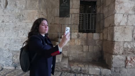 young tourist taking selfie at zion gate in jerusalem. slow motion.