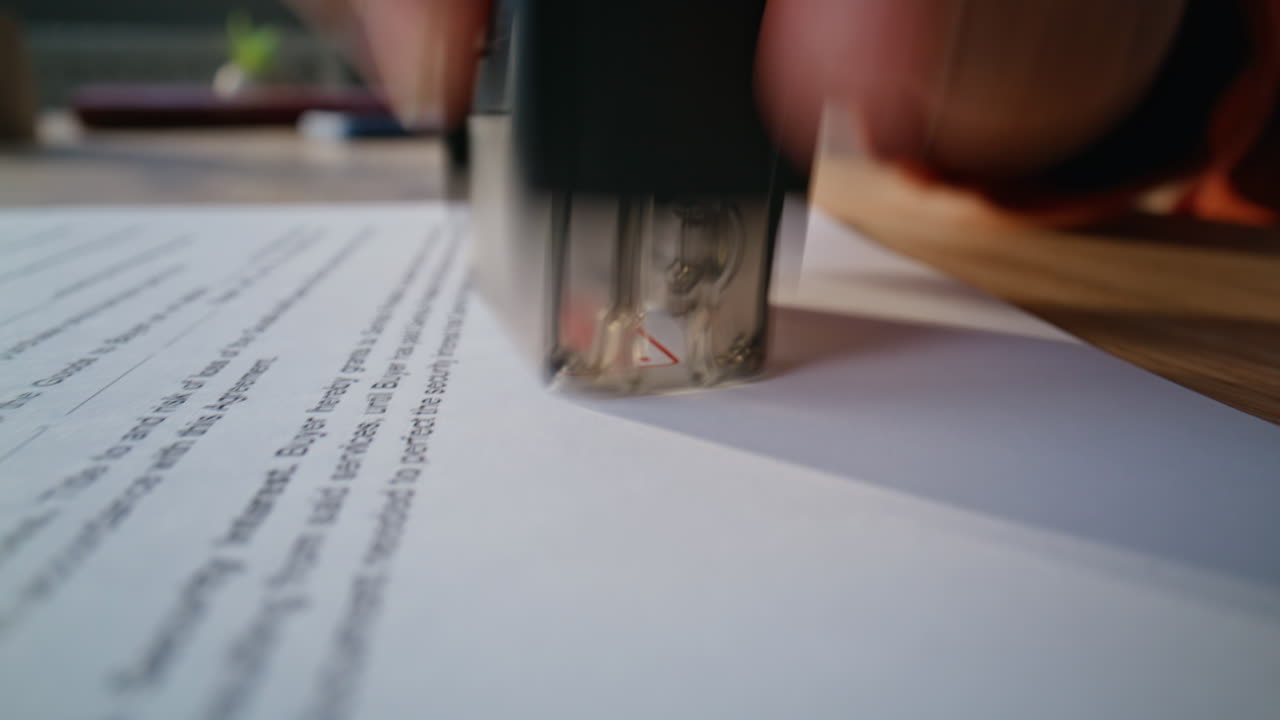Hand stamping business contract placed on workspace closeup. Unknown businessman