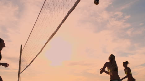 beautiful bikini girls on the beach play volleyball in slow motion