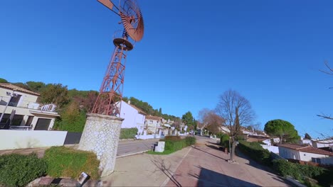 emocionante vuelo de drones fpv alrededor de un viejo molino de viento gigante en el corazón de un pueblo