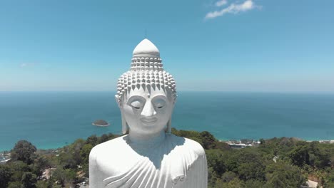 Majestic-Big-Buddha-sitting-atop-Nakkerd-Hill-looking-after-Chalong-in-Phuket,-Thailand---Aerial-Orbit-Wide-panorama-reveal