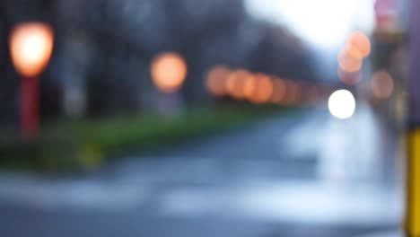 out-of-focus lights along a street at dusk