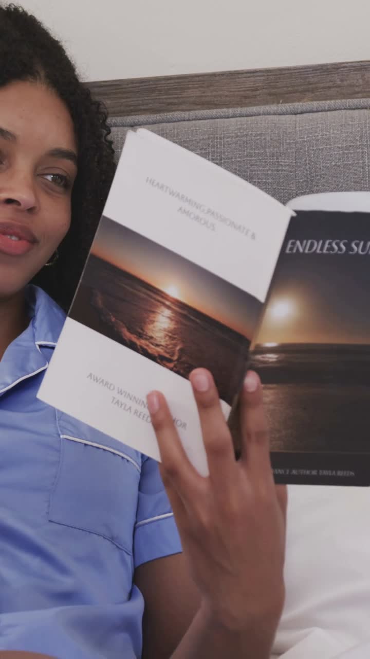 Vertical video: Spotting sunset photograph, woman in pajama top flipping magazine on bed relaxing