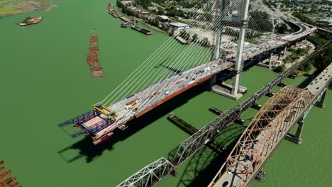 pattullo bridge replacement under construction next to railroad bridge and old pattullo bridge in bc, canada. - aerial shot