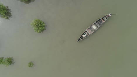 aerial bird's eye view drone shot of indian men fishing on a dhow canoe boat