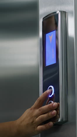 nurse comes to elevator door and presses call button. close up shot of nurse in uniform coming to elevator door and pressing call button. health care specialists at work in modern hospital. medical worker uses elevator in working process. vertical shot