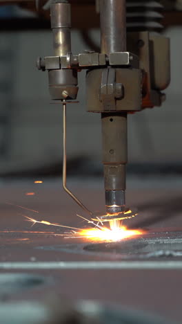 laser plasma cutting of metal. modern industrial technology. industrial laser cutter with sparks. close up vertical video