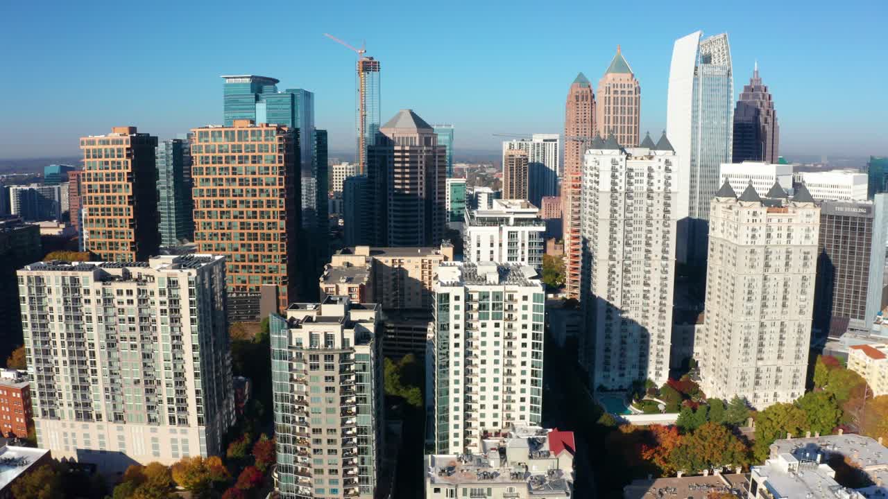 Slowly flying away from skyscrapers in downtown Atlanta Georgia during Fall