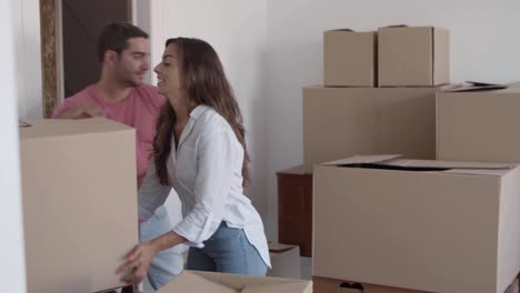 hombre feliz dando cajas de cartón a la novia que las pone sobre la mesa