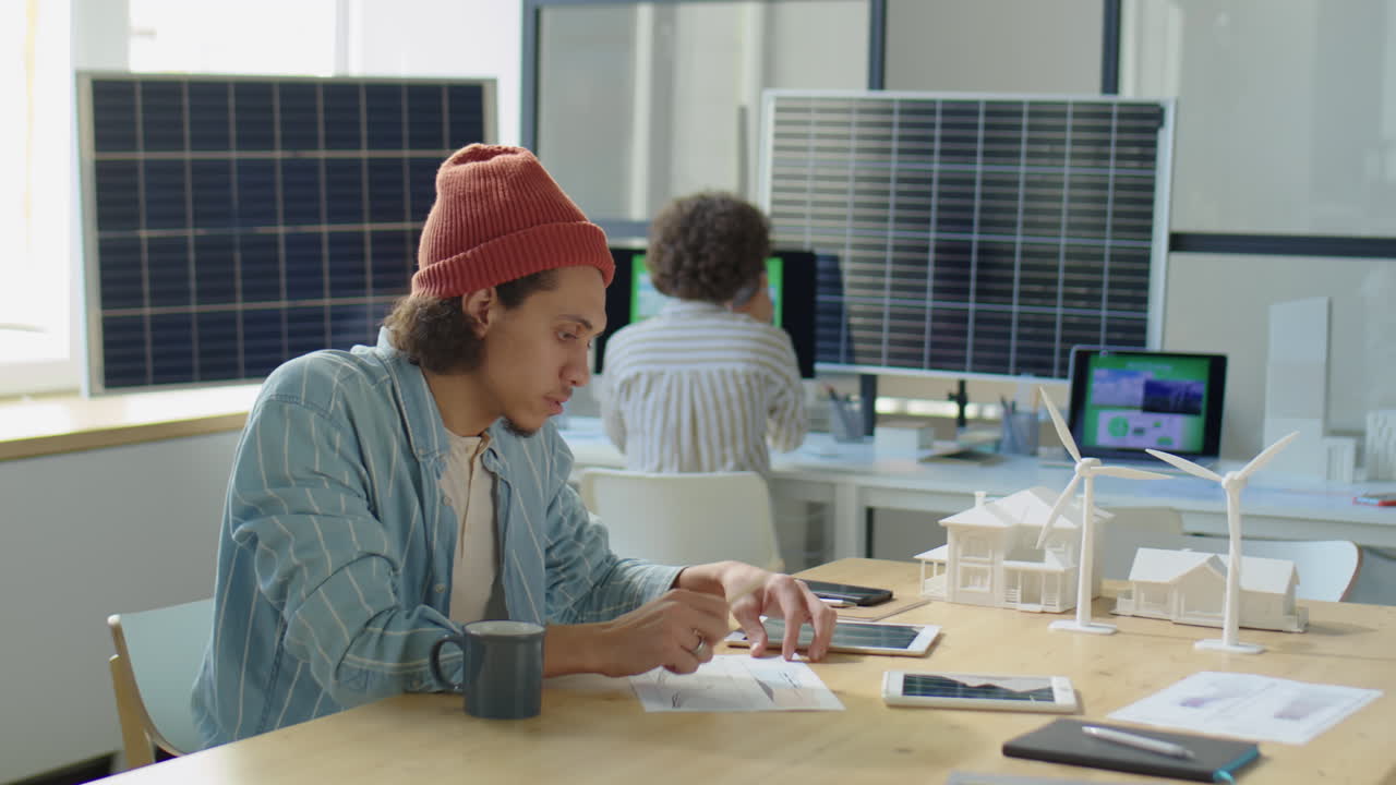 Coworkers Shaking Hands and Discussing Renewable Energy Project
