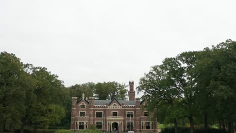 tilt down from cloudy sky to schaffelaar castle in barneveld, the netherlands