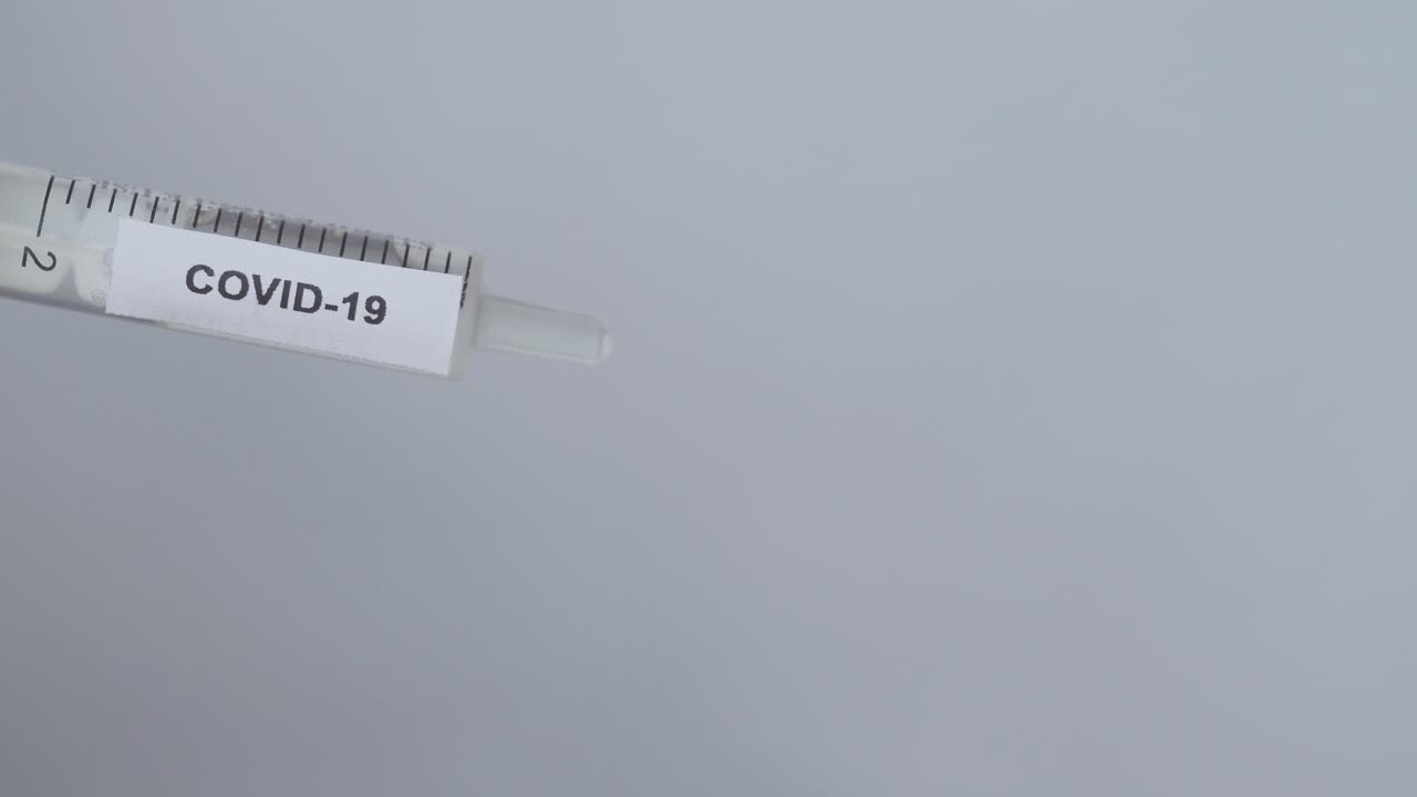 Doctor's Hand Putting Needle On Syringe For Covid 19 Vaccine, Close Up