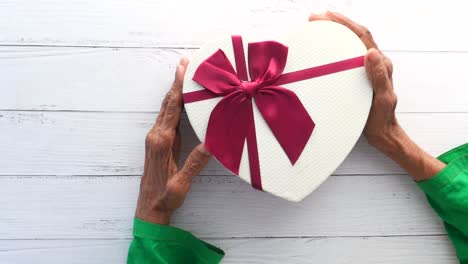 heart-shaped gift box in hands